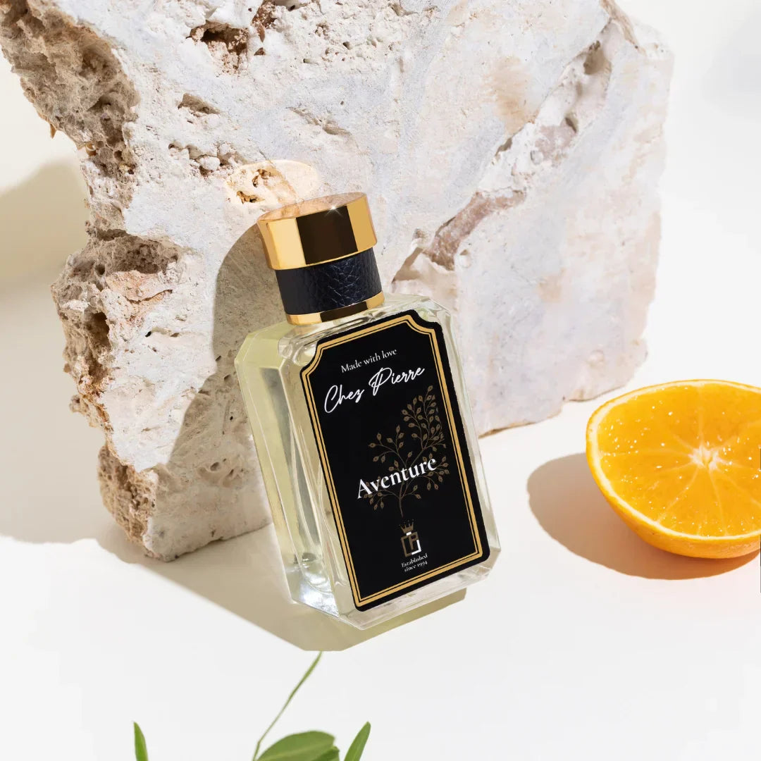 Chez Pierre luxury men's perfume bottle styled with cinnamon and tea leaves on dark leather background – available at Opulent Perfumes UAE