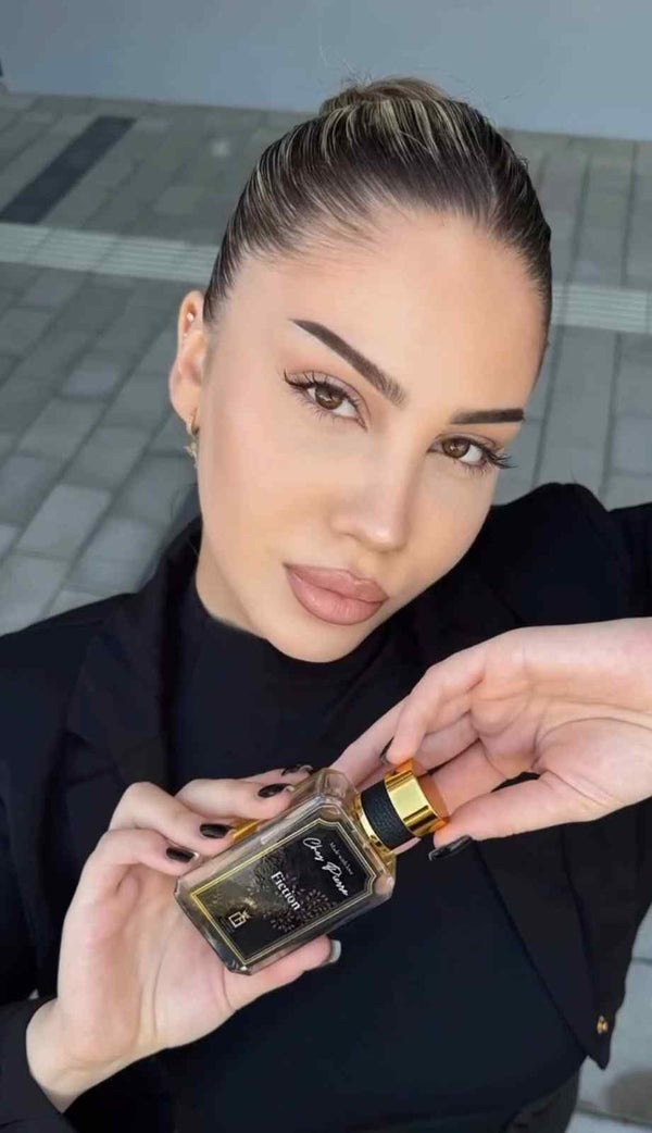 : A close-up view of a premium Chez Pierre perfume bottle spraying a high-concentration feminine fragrance mist