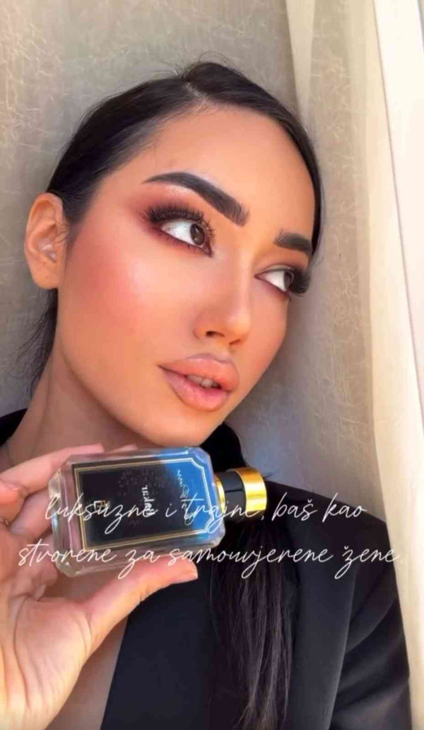 A female customer displaying a beautiful bottle from Chez Pierre Perfumes at a lifestyle location in Dubai