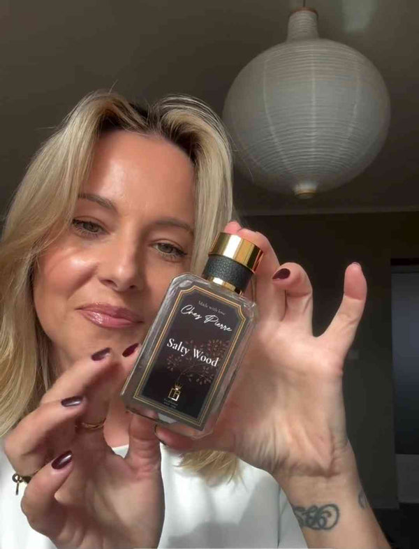 A happy woman receiving an elegant Chez Pierre fragrance gift package delivered to her door