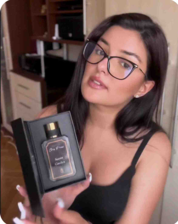 A happy woman holding her premium Chez Pierre perfume box after a successful delivery checkout.
